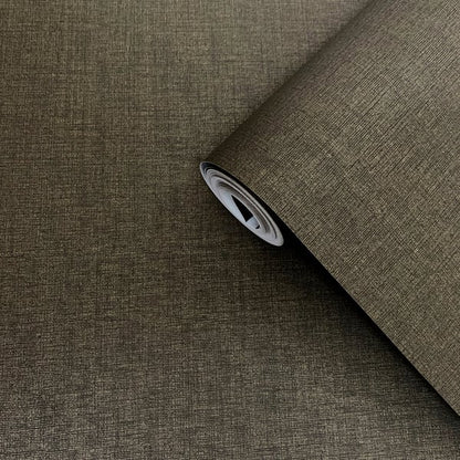 Brown plain wallpaper roll with a subtle sheen, partially unrolled on a dark brown surface.