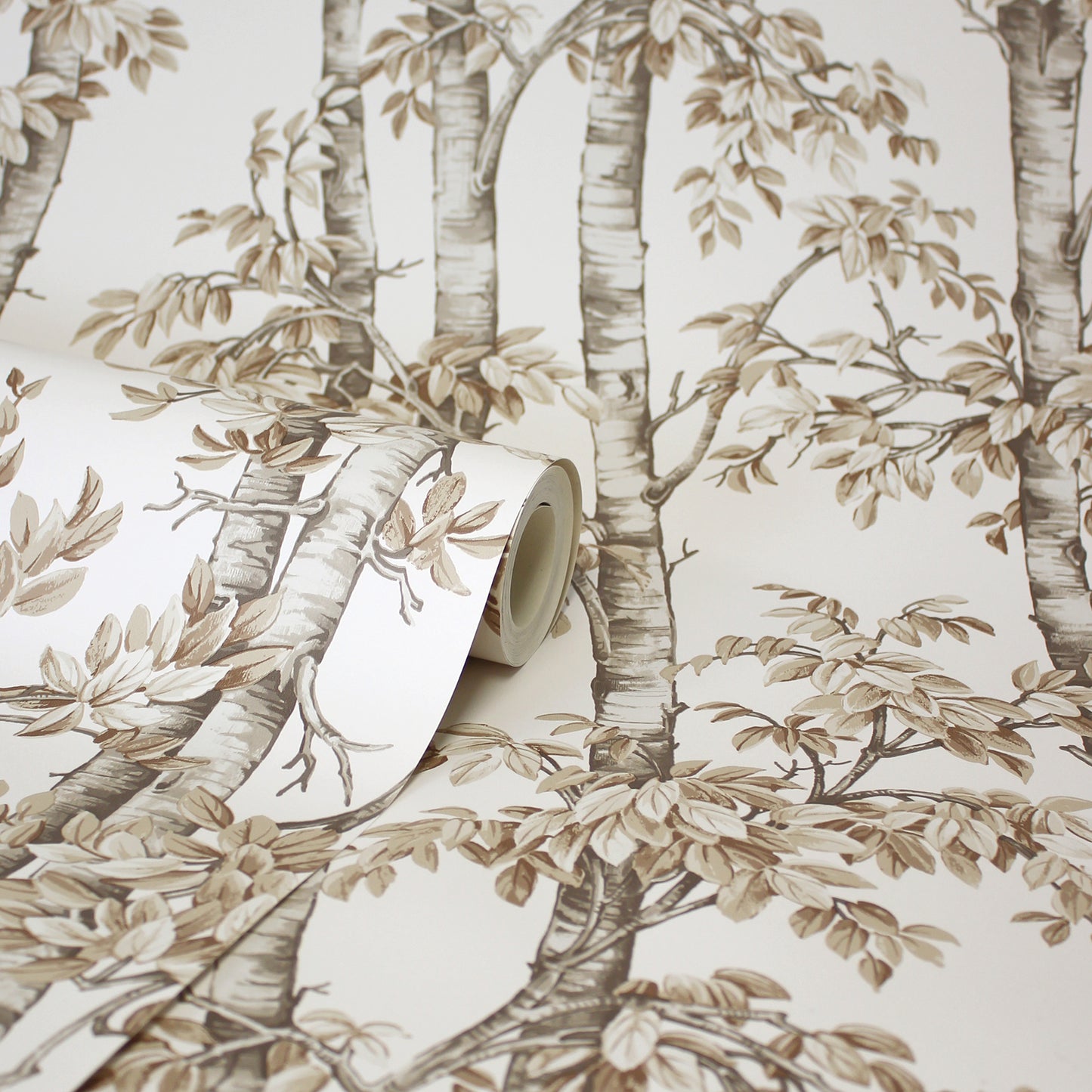 Beige-brown neutral trees wallpaper with leafy branches; roll partly unrolled.