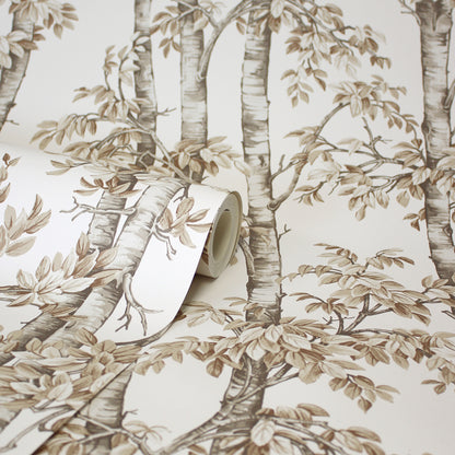 Beige-brown neutral trees wallpaper with leafy branches; roll partly unrolled.