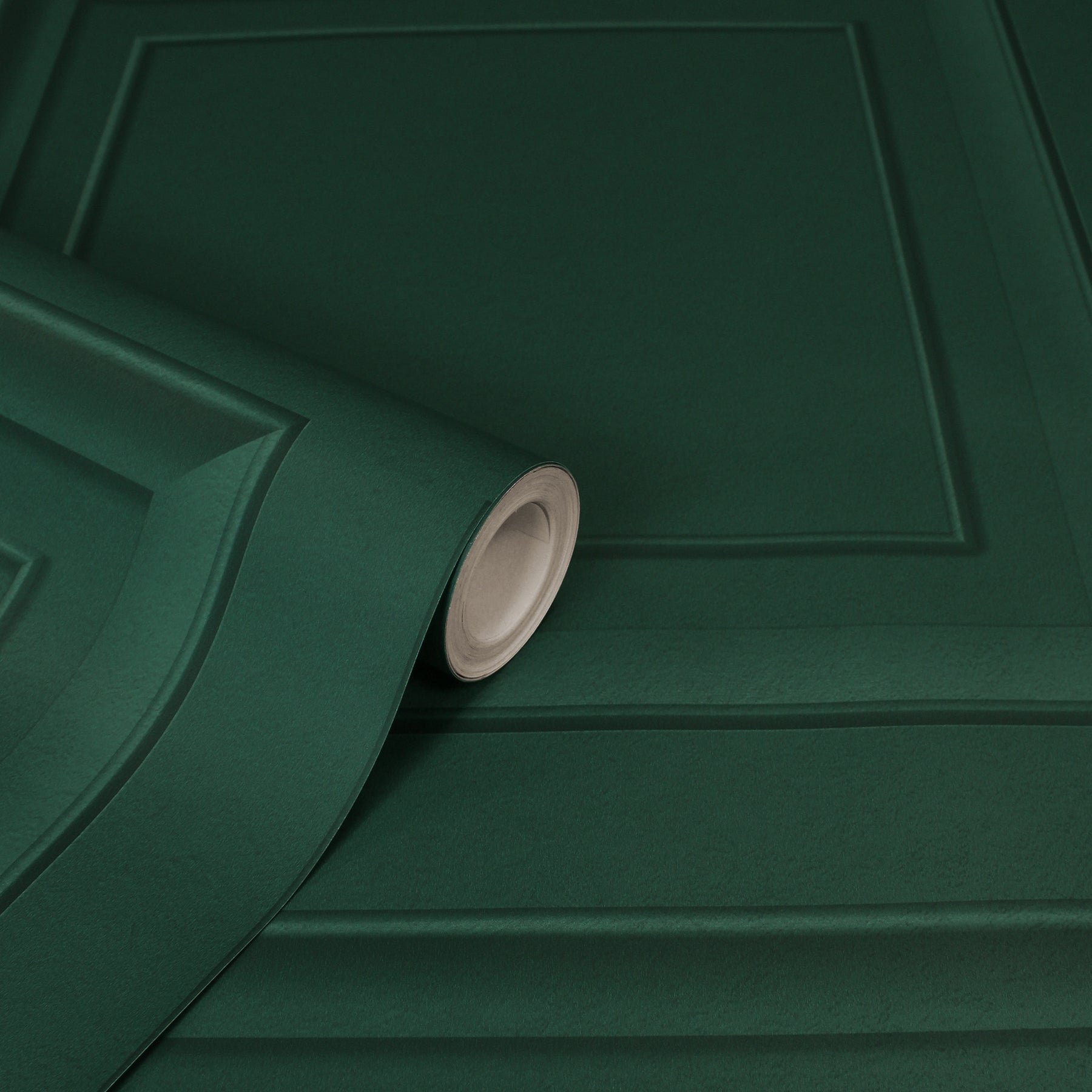 Dark green wallpaper roll with embossed square panel pattern, curling at the edge.