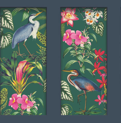 Two vertical tropical panels with dark borders; left heron among green leaves and pink blooms, right heron beside orchids.
