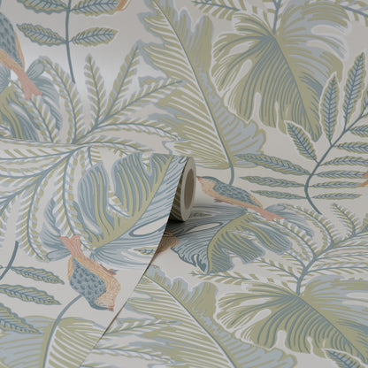 Rolled tropical wallpaper sample with pastel palm leaves and ferns, peach birds, in blue-green, sage and beige.