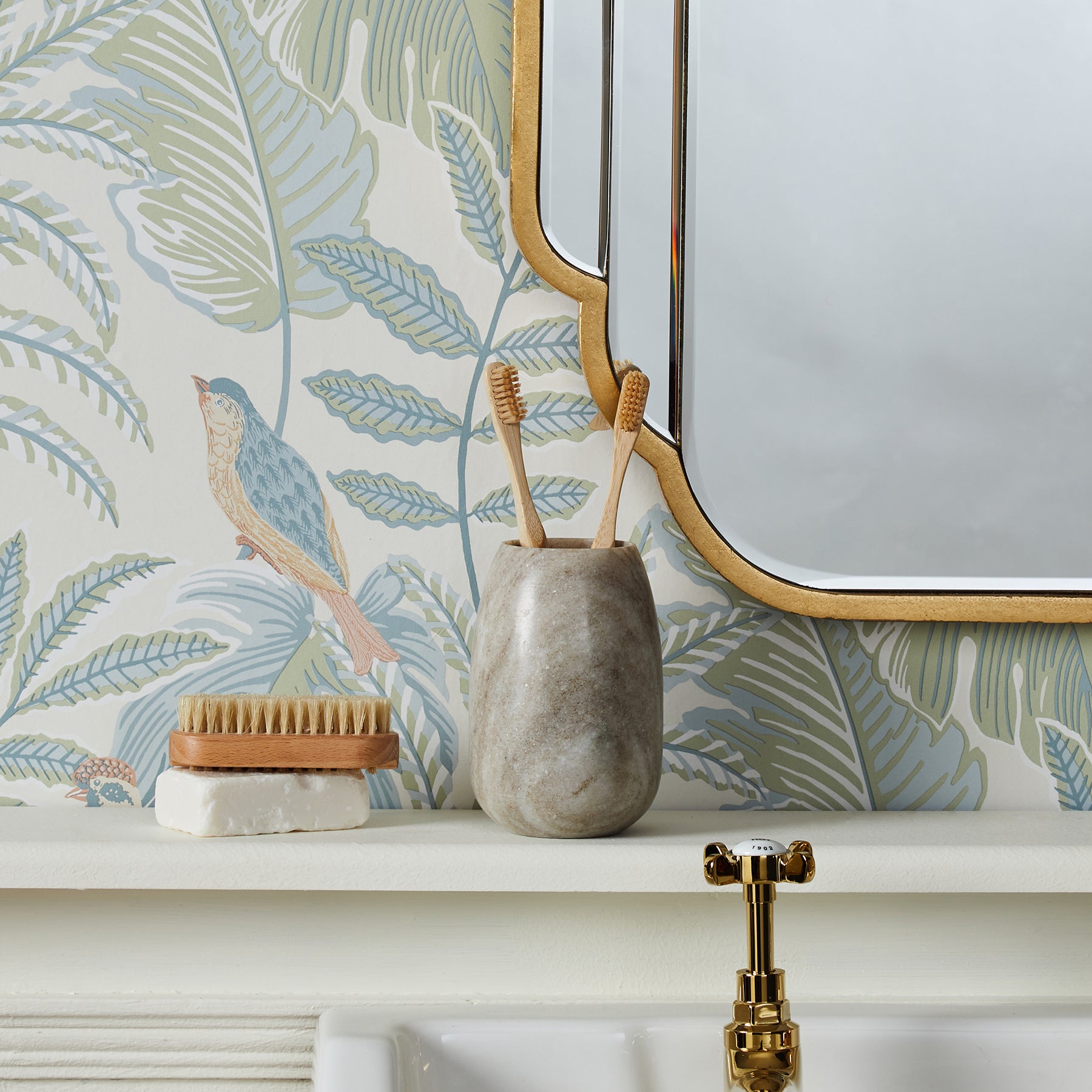 Pastel tropical animal wallpaper on a wall in a room.