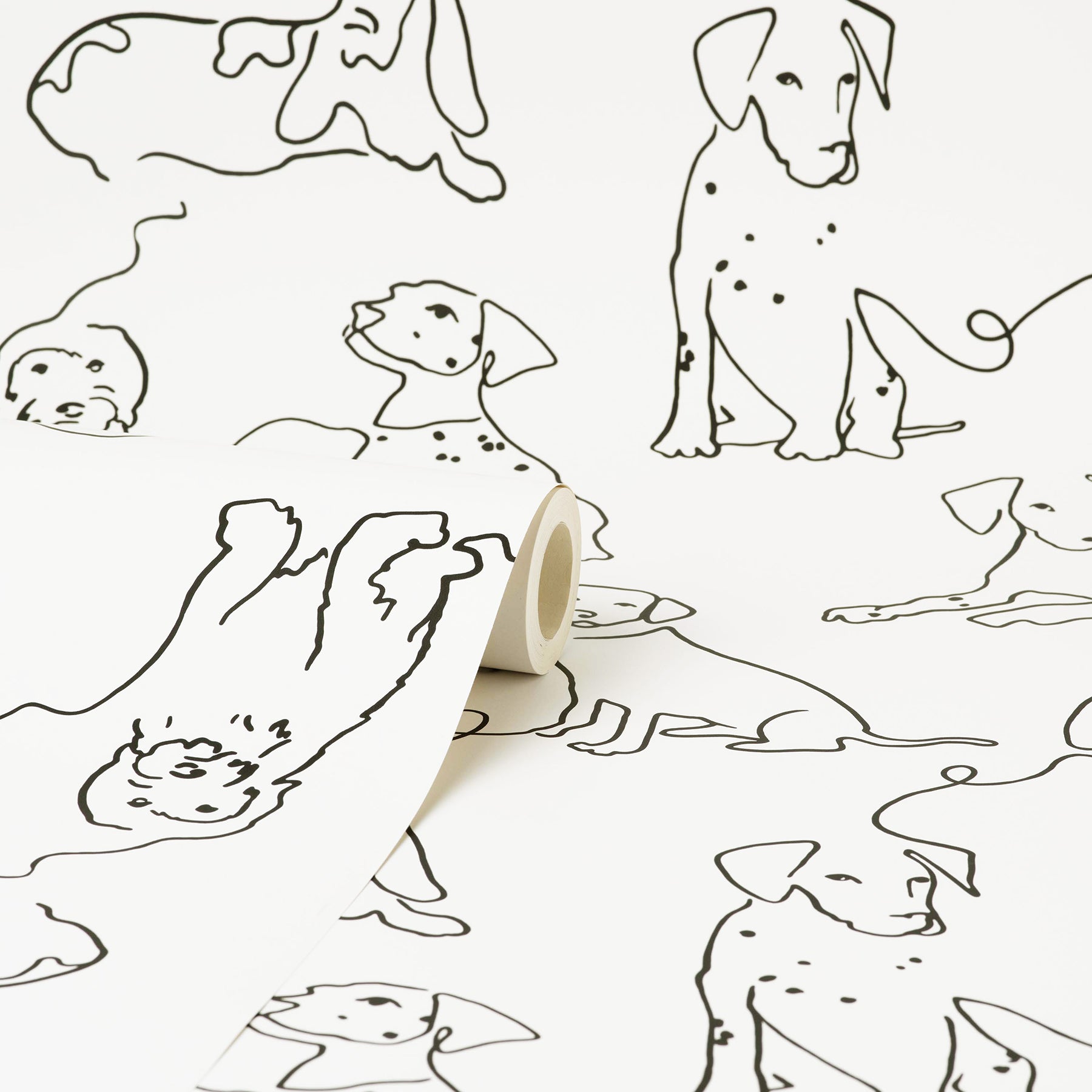 Roll of wallpaper with black line-dog illustrations; minimalist, playful canine sketches on white paper.
