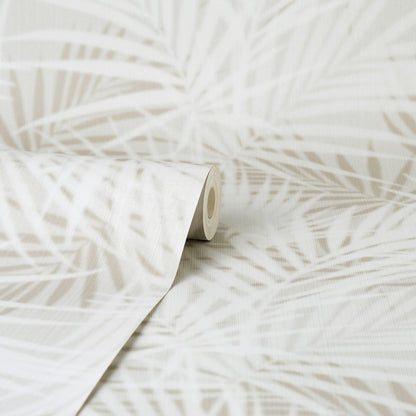Beige wallpaper roll with white palm leaf pattern; tropical, contemporary wall decor, rolled at edge.
