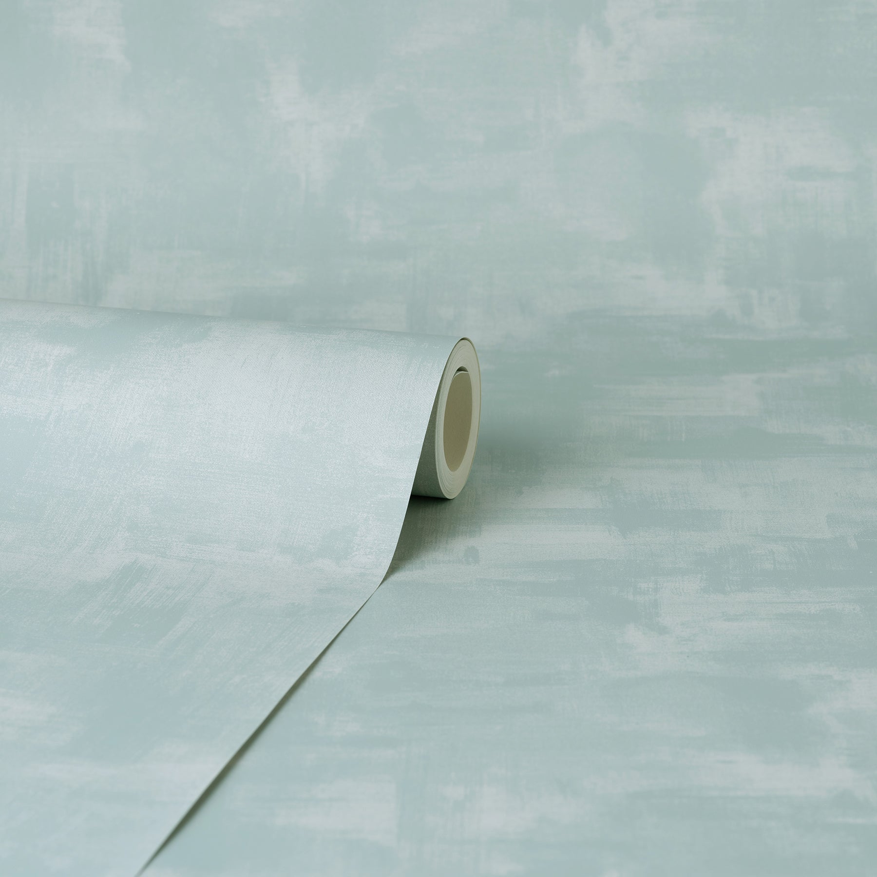 Mint green textured wallpaper roll, partially unrolled on a pale background.