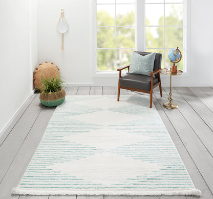 Bright room with a pale blue woven rug, mid-century wood-framed chair, brass side table with globe, and potted greenery.
