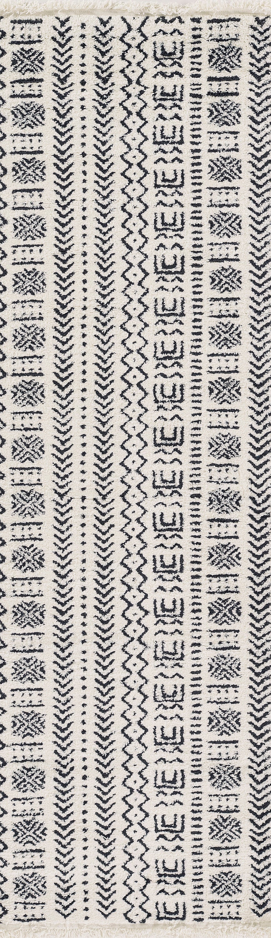 Beige woven rug with narrow vertical black geometric stripes featuring chevrons, diamonds and zigzags.