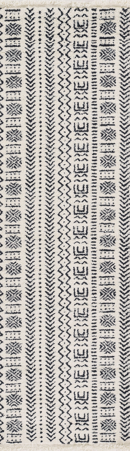Beige woven rug with narrow vertical black geometric stripes featuring chevrons, diamonds and zigzags.