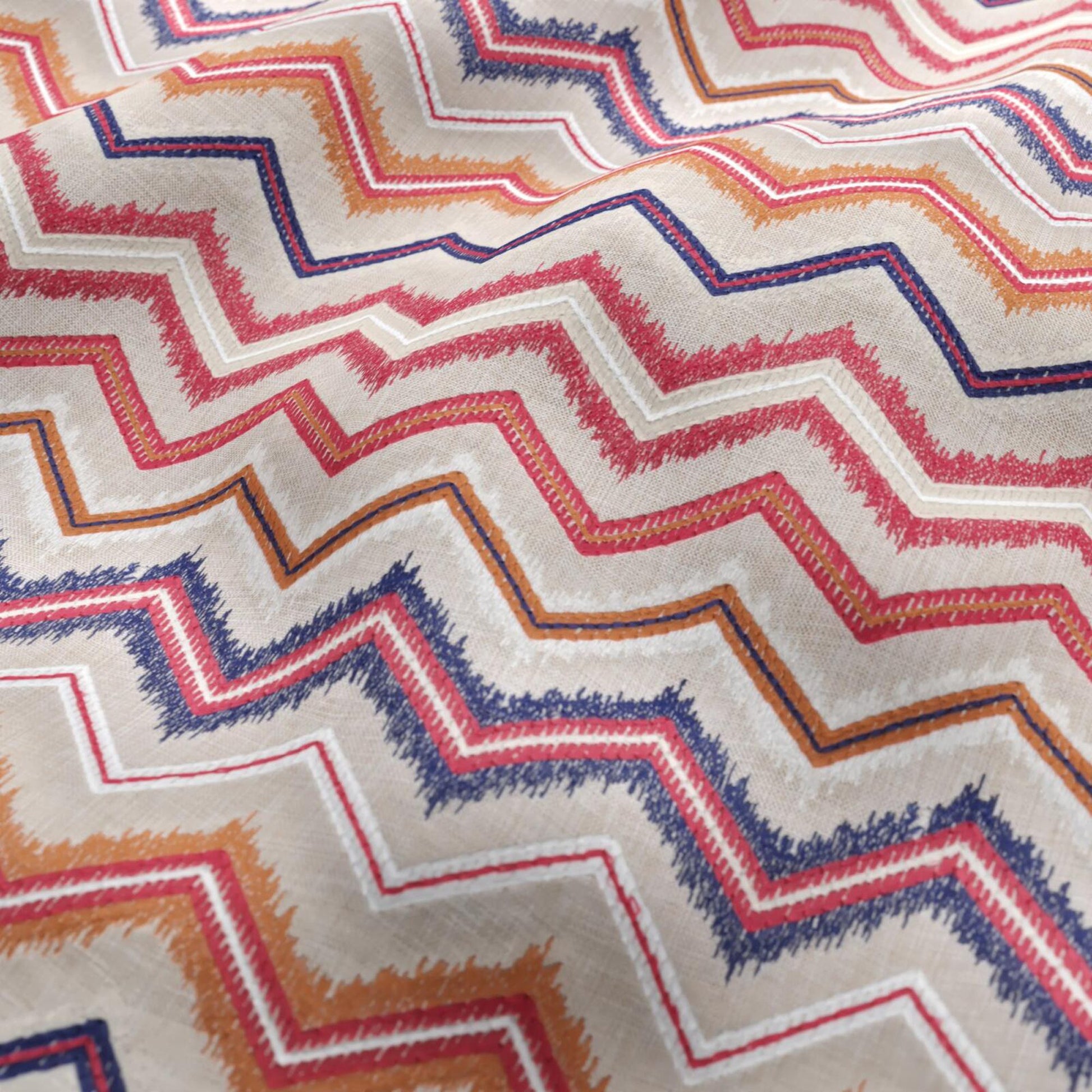 Beige linen-textured woven fabric with a geometric chevron pattern in white, orange, light red and navy.