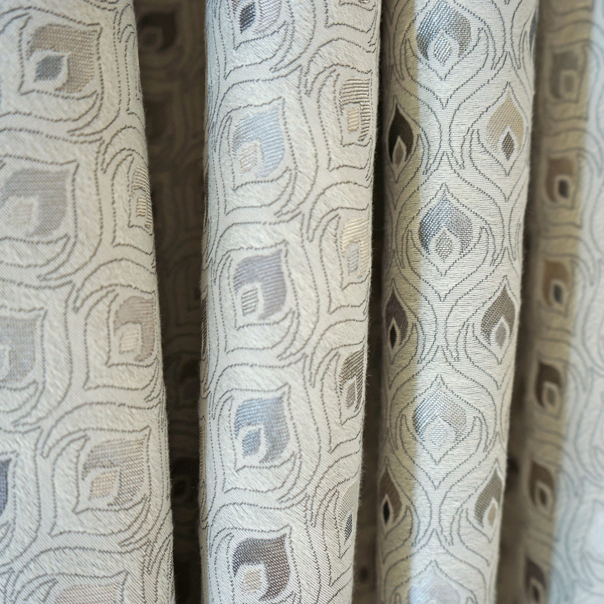 Woven jacquard fabric with pale blue & taupe diamond motifs on beige; versatile curtain or upholstery textile.