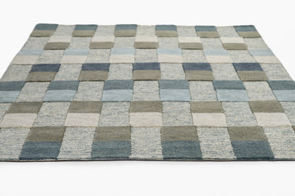 Blue-gray checkerboard flat-weave rug with light and dark squares; modern geometric floor decor.