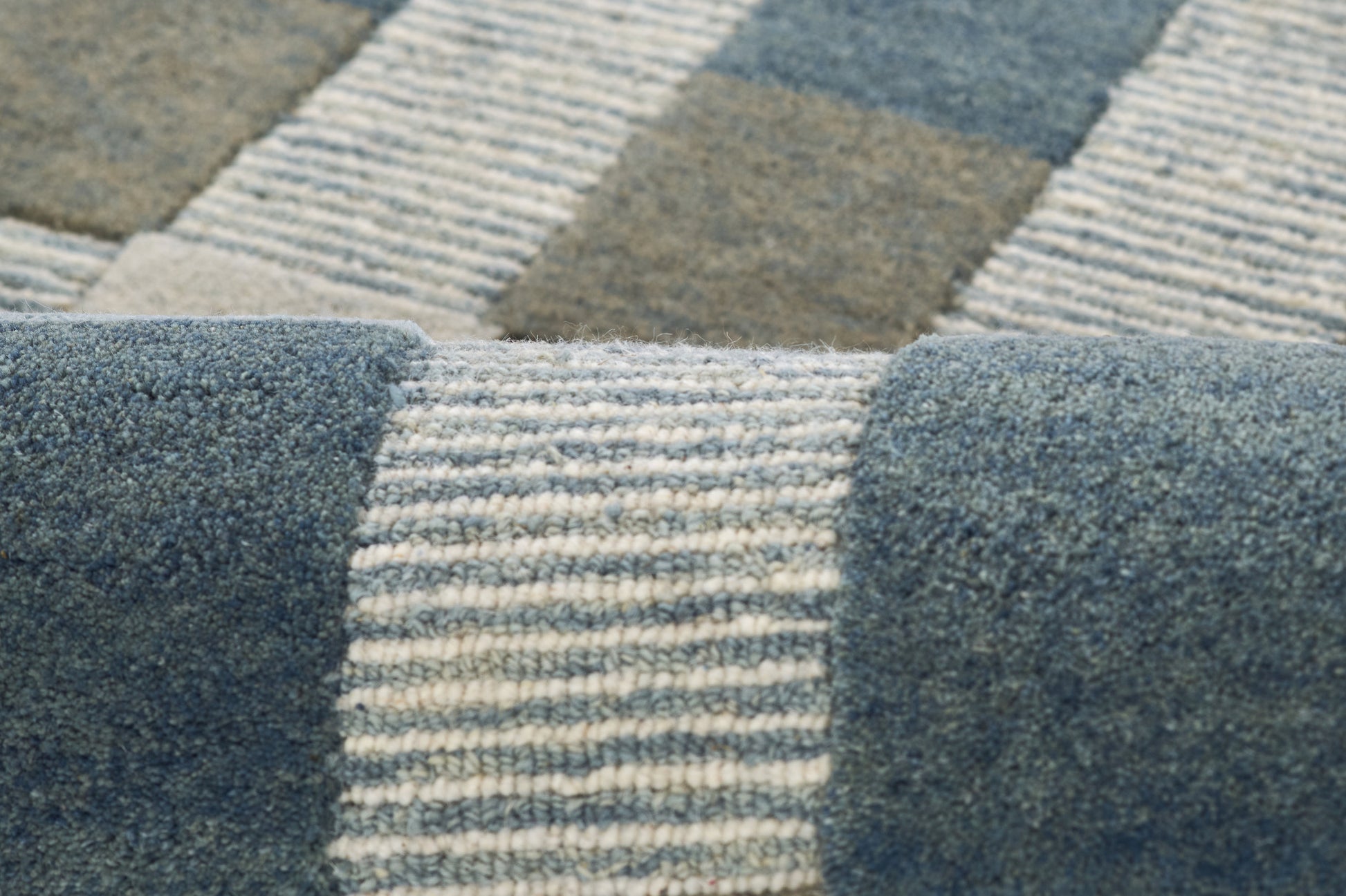 Blue, gray & cream woven rug with striped patchwork blocks; textured, contemporary home decor.