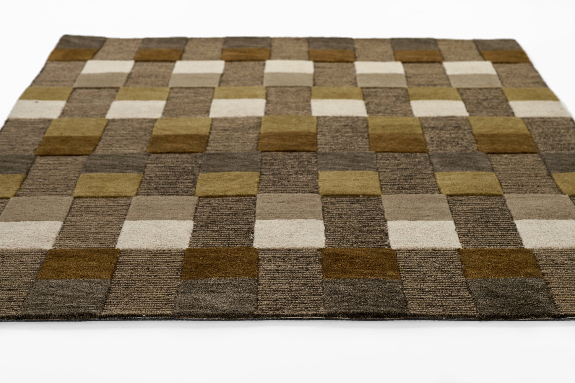 Patchwork checkerboard rug in brown, beige, and tan squares with a plush woven texture.