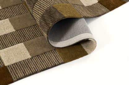 Brown patchwork rug with tan and beige squares; soft felt texture, folded corner shows gray backing