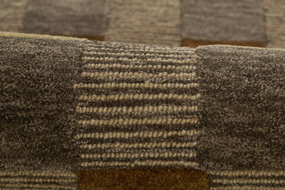 Close-up of brown patchwork rug with dark blocks and striped center panel, plush textured pile.