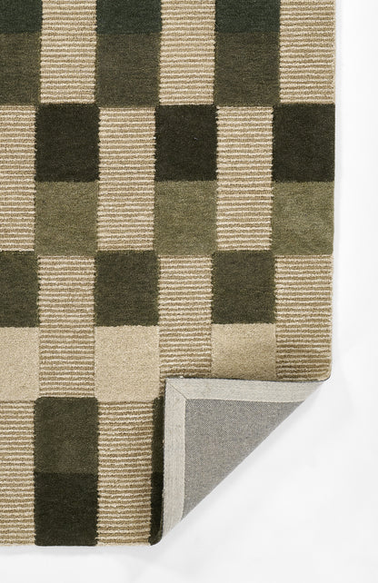 Rectangular rug in olive green and beige checkerboard with textured striped squares; corner folded to show gray backing.