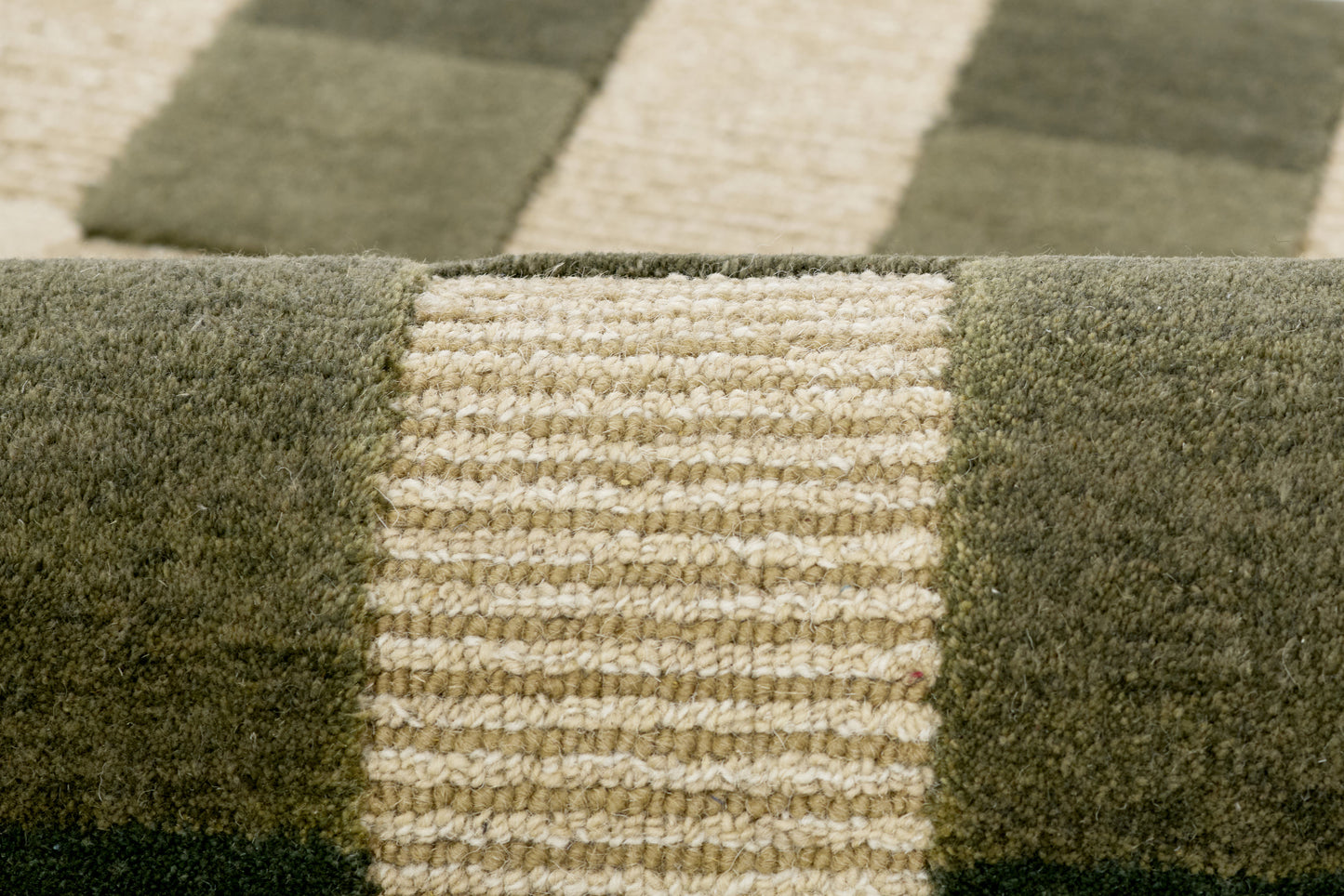 Olive green & beige striped plush area rug with chunky pile and geometric block pattern.
