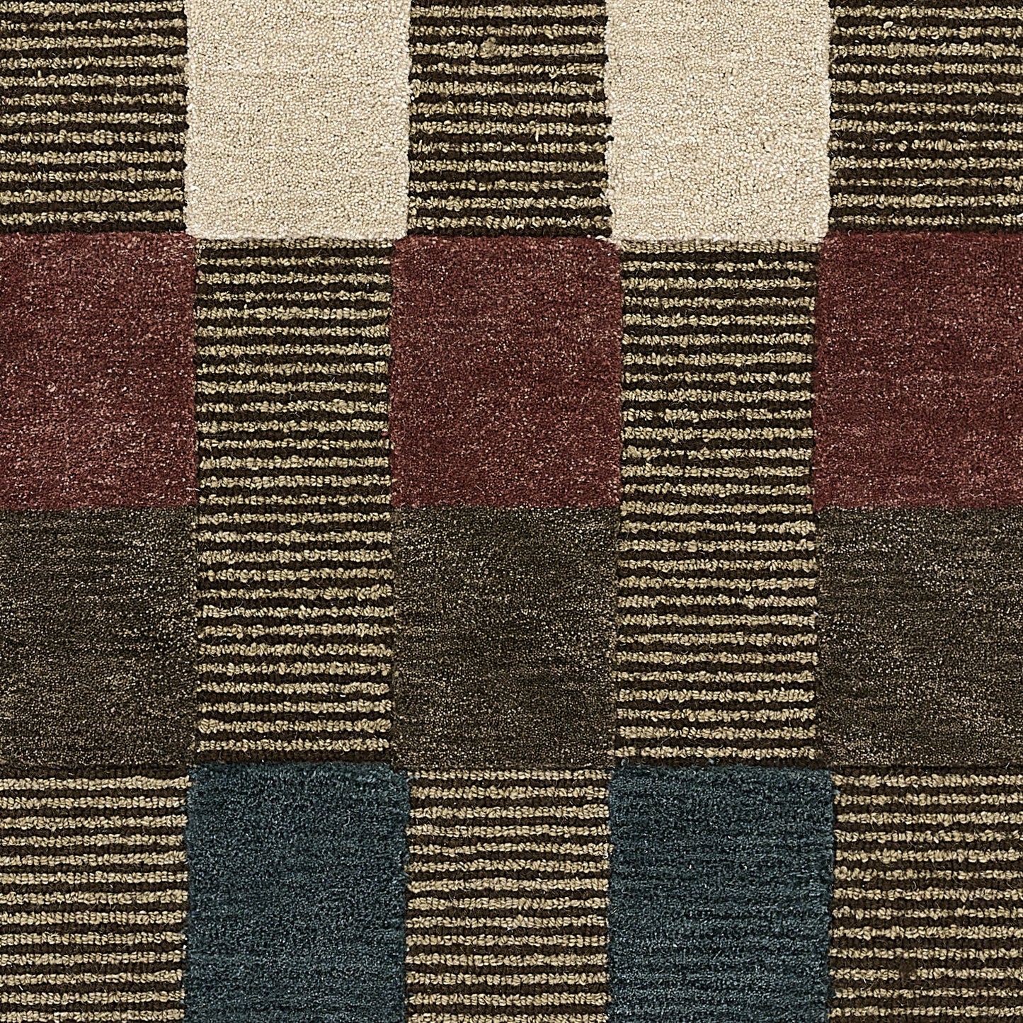 Geometric woven area rug with cream, maroon, tan, charcoal & navy blocks in a checkerboard pattern; textured, low-pile.