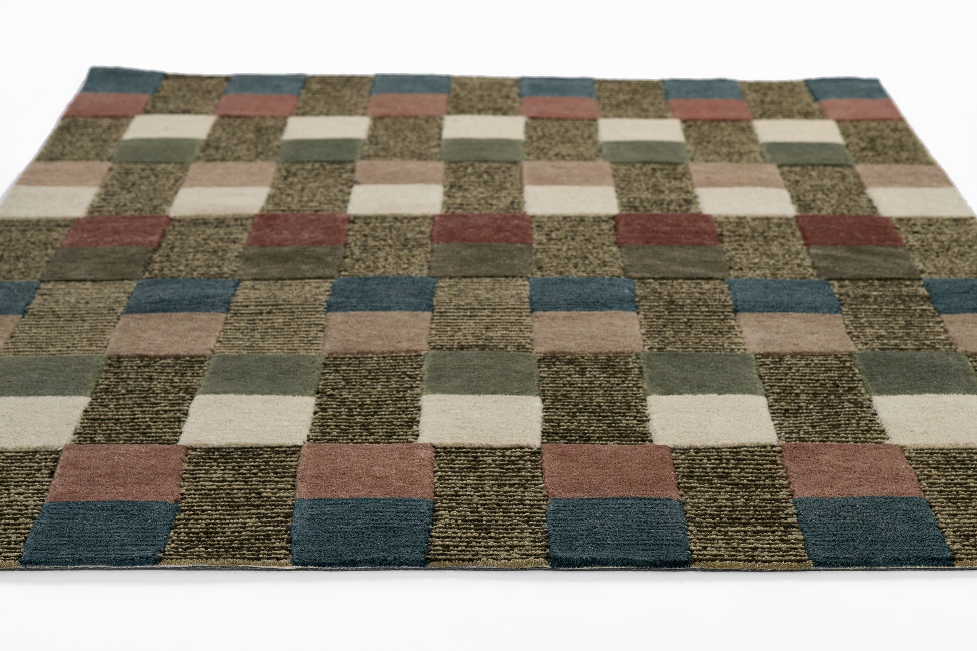 Patchwork runner rug with square blocks in brown, beige, cream, gray, green, and blue; textured, low-pile, geometric style.