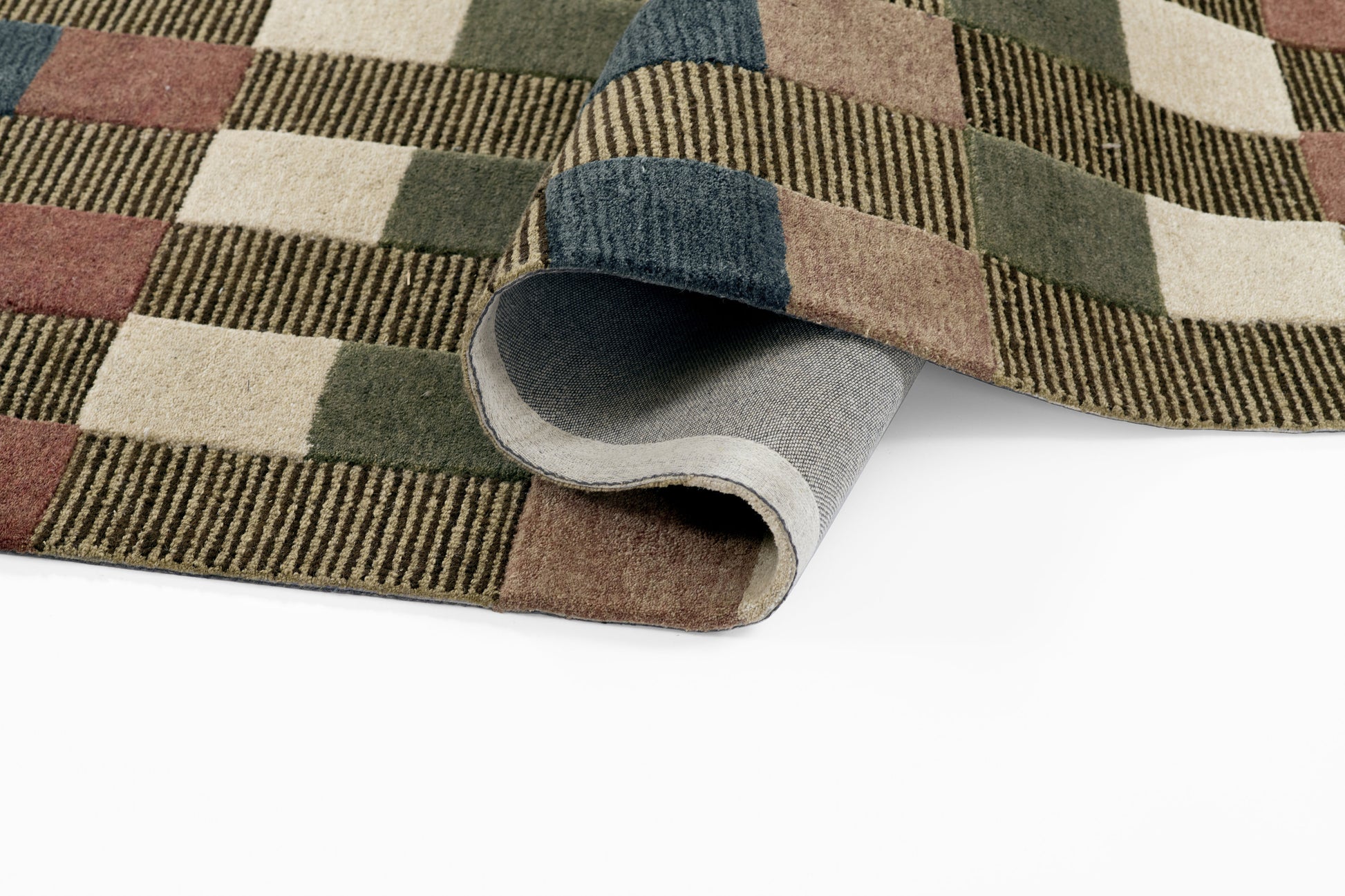 Multi-color plaid wool rug with earthy greens, browns, blues and whites; rolled corner shows soft underside.