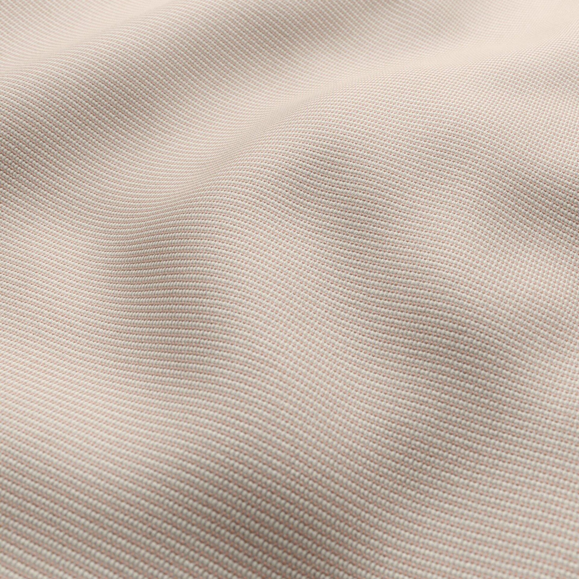 Close-up of pink outdoor basketweave fabric with a fine woven texture and soft folds.