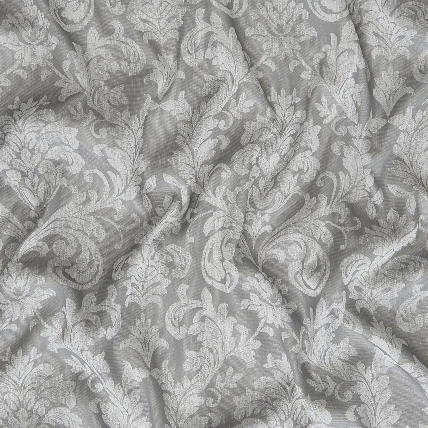 Gray damask patterned fabric with white floral scroll motif and soft drape.