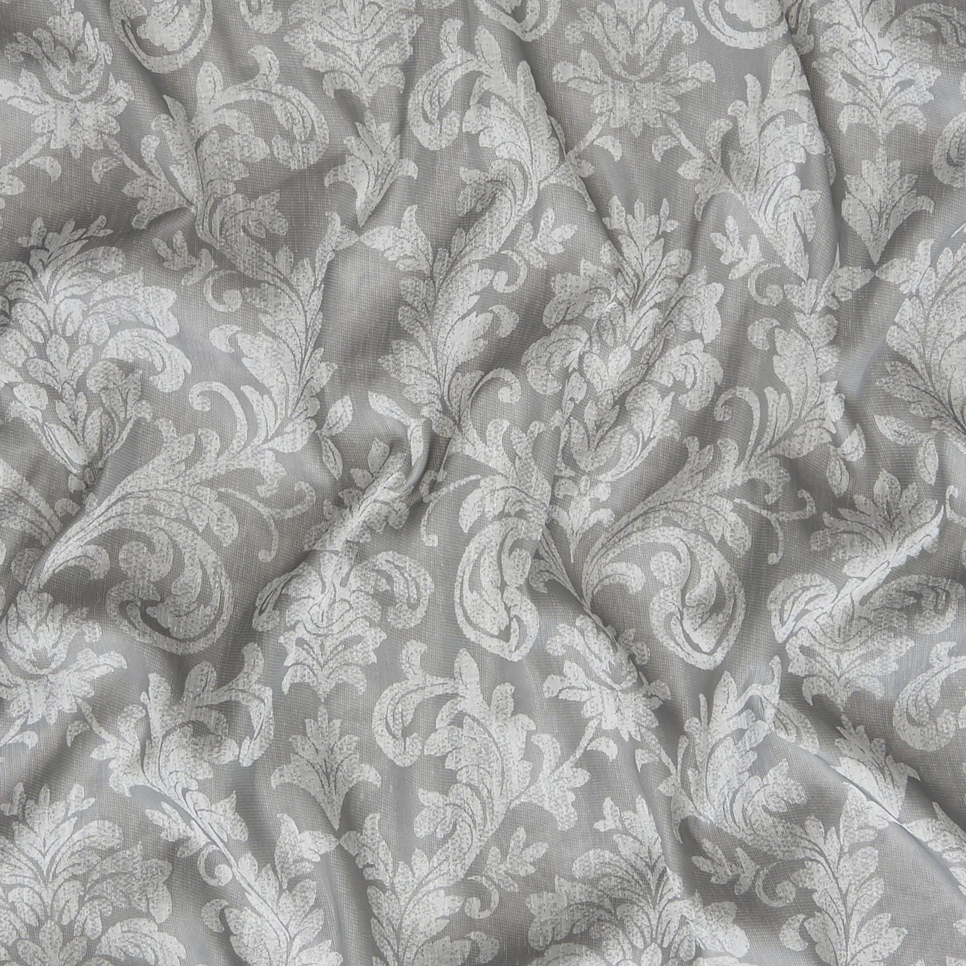 Gray damask patterned fabric with white floral scroll motif and soft drape.