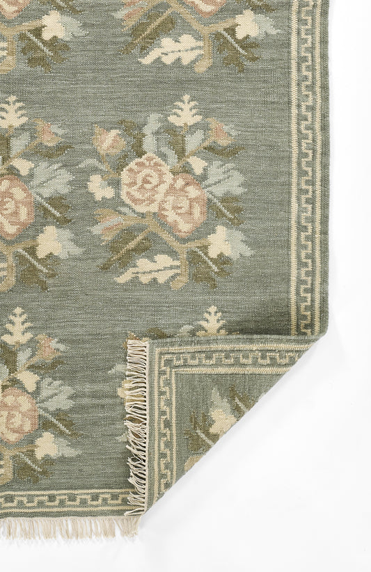 Muted blue-green floral runner with pale pink blooms, ivory accents, and a Greek-key border with fringe.
