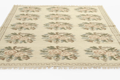 Cream rug with repeating pink rose bouquets, sage leaves, beige border and fringed edges; Persian-inspired design.