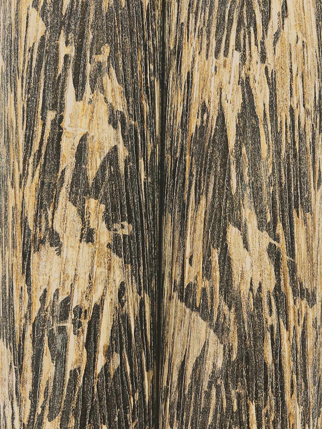 Close-up of wallpaper texture with bold black and beige streaks in an abstract pattern.