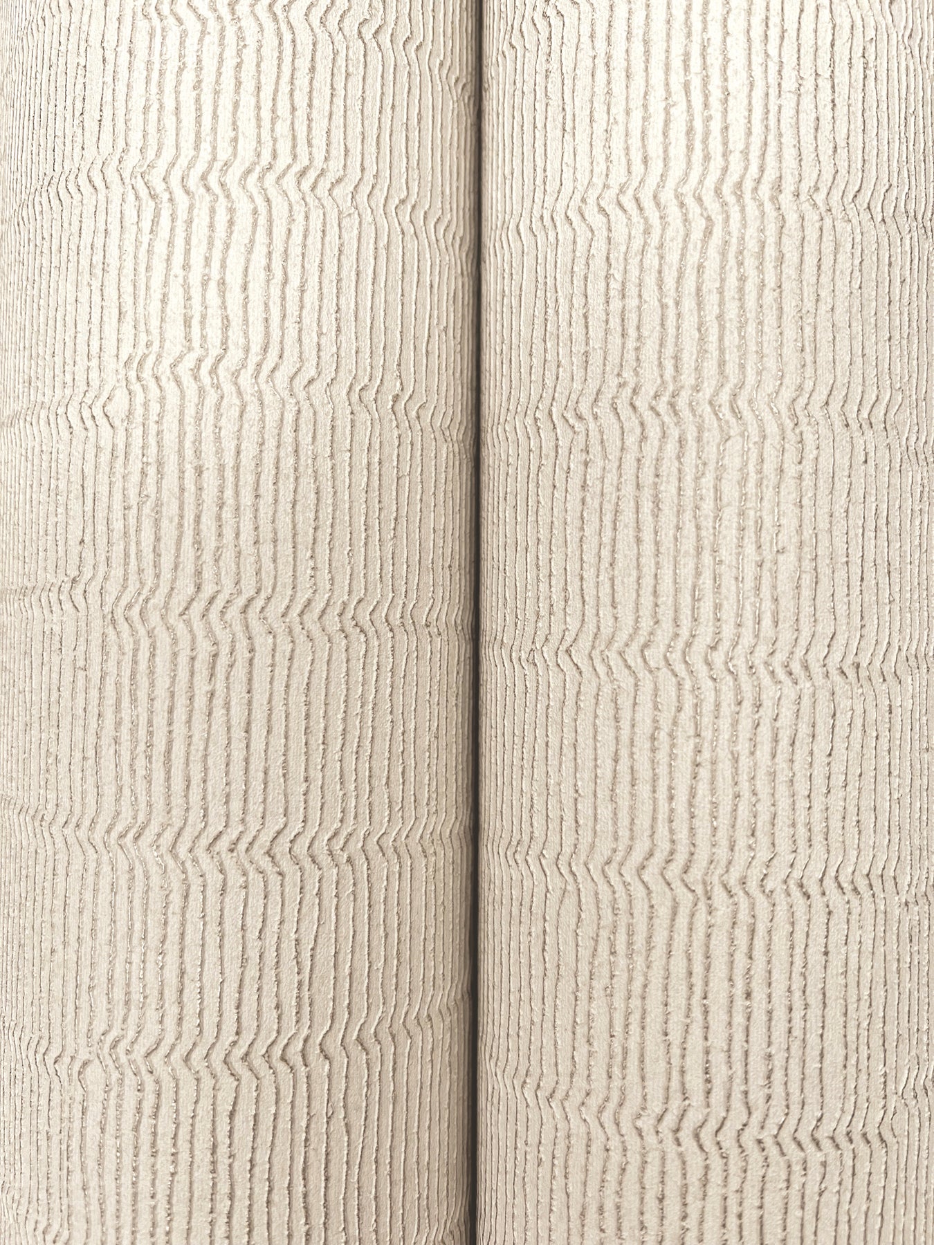 Two beige textured wallpaper rolls with subtle vertical wavy stripes and a fabric-like surface.