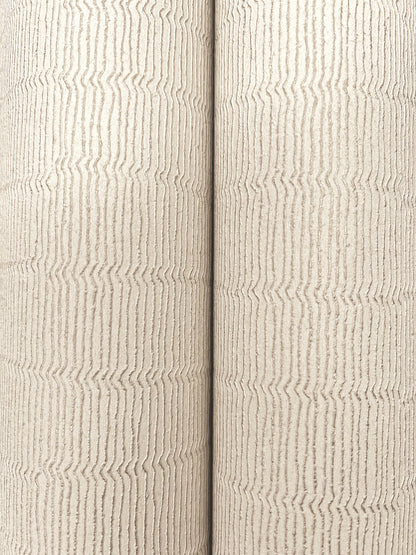 Two beige textured wallpaper rolls with subtle vertical wavy stripes and a fabric-like surface.