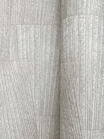 Close-up of stone-grey wallpaper with a geometric pattern and metallic sheen.