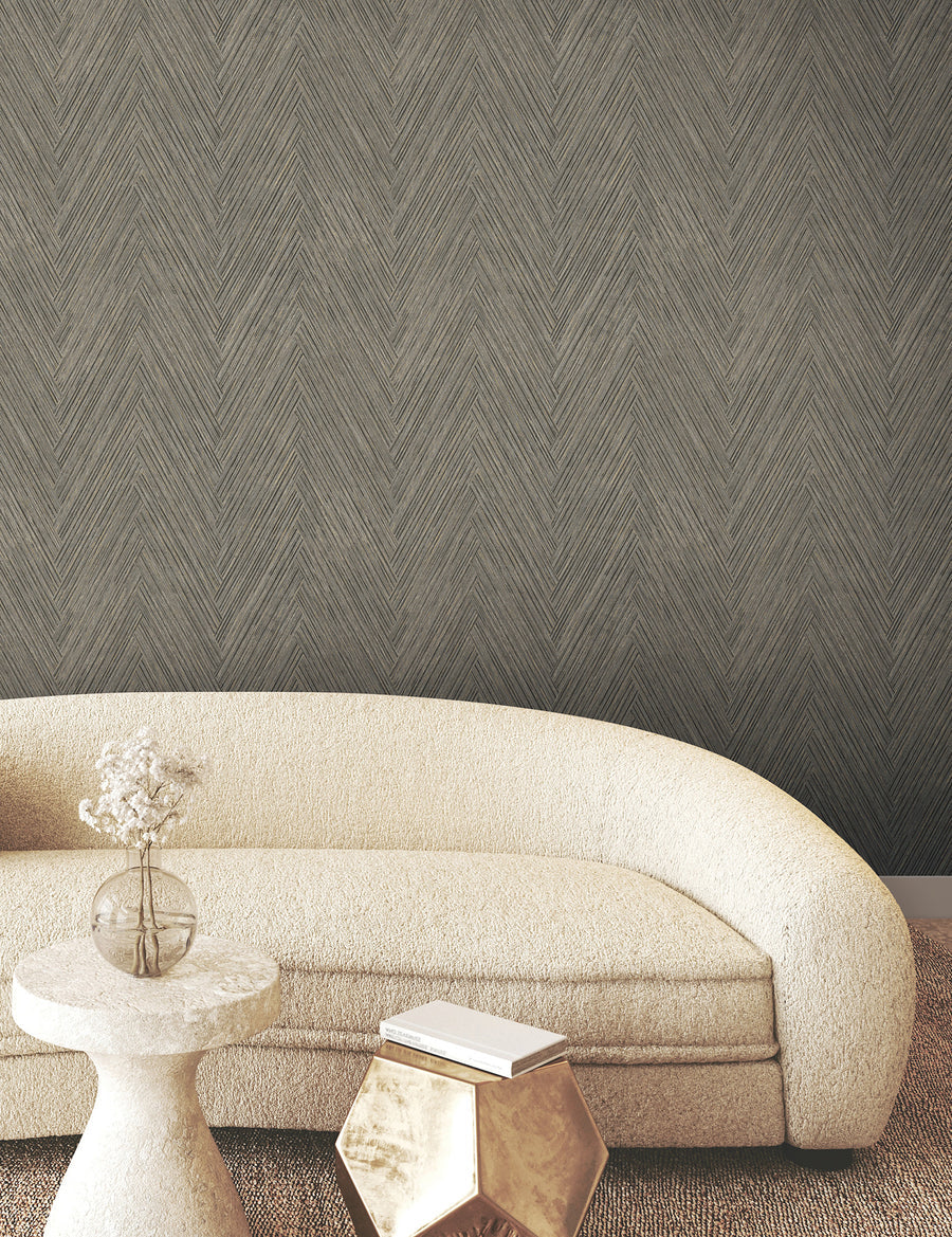 Thatched Chevron Wallpaper in charcoal featuring a dimensional woven pattern with interlaced geometric lines, earthy gray tones, and subtle gold metallic detailing for modern and transitional interiors.