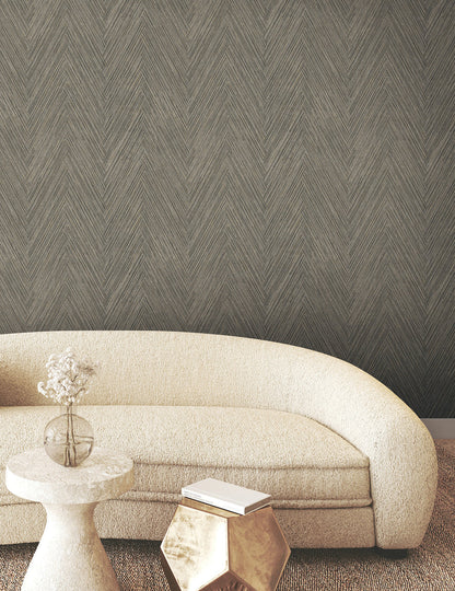 Thatched Chevron Wallpaper in charcoal featuring a dimensional woven pattern with interlaced geometric lines, earthy gray tones, and subtle gold metallic detailing for modern and transitional interiors.
