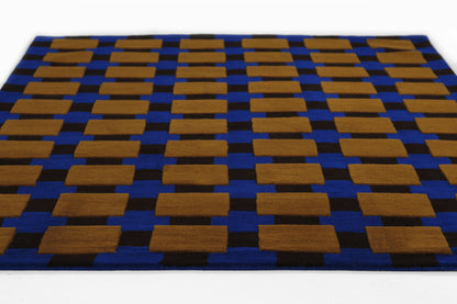 Blue, soft woven rug with tan-brown rectangular blocks in a repeating geometric grid.
