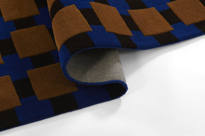 Blue and brown checkerboard wool scarf with grey fleece backing, folded edge.