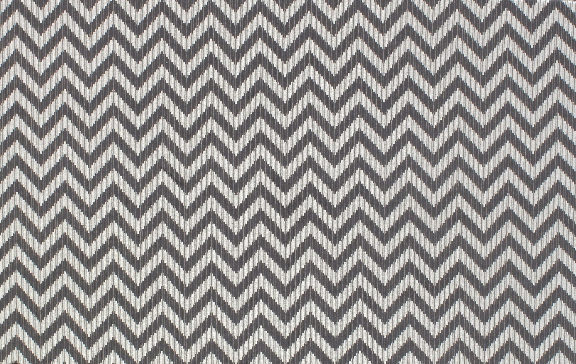 Grey & white chevron fabric with woven texture, modern zigzag pattern for upholstery or apparel.