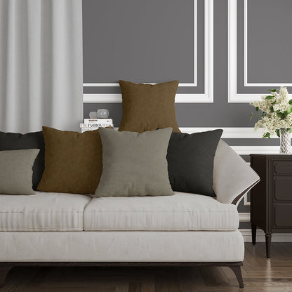 Chocolate solid fabric upholstery on a sofa; cushions in olive, brown, taupe and gray; dark wood legs; gray walls; white molding; vase of flowers.