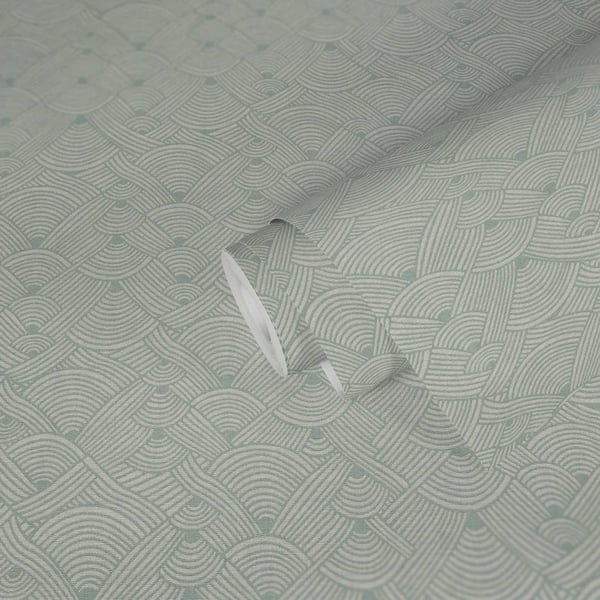 Light sage-green wallcovering with a geometric swirl motif; subtle texture visible in the soft fold.