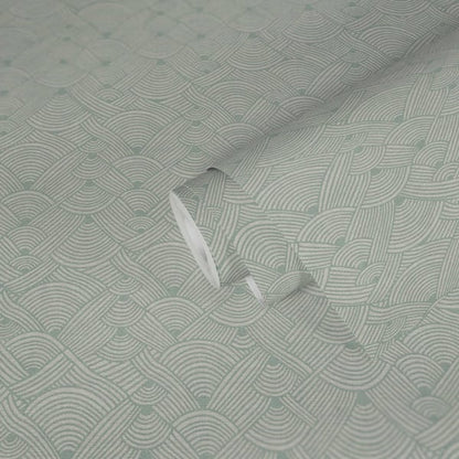 Light sage-green wallcovering with a geometric swirl motif; subtle texture visible in the soft fold.