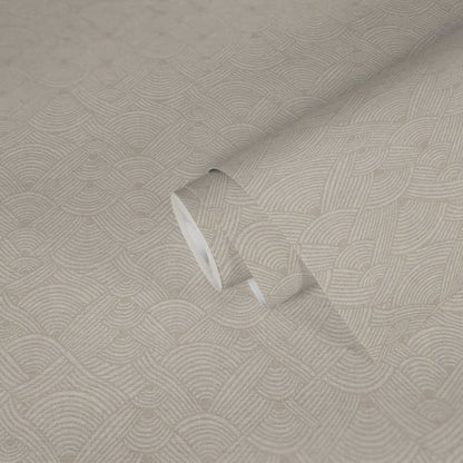 Beige wallcovering with interlocking circular swirl motif; close-up shows a folded edge.