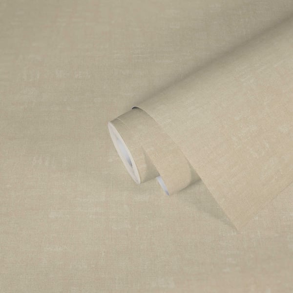 Beige linen fabric roll with textured weave, partially unrolled on pale background.