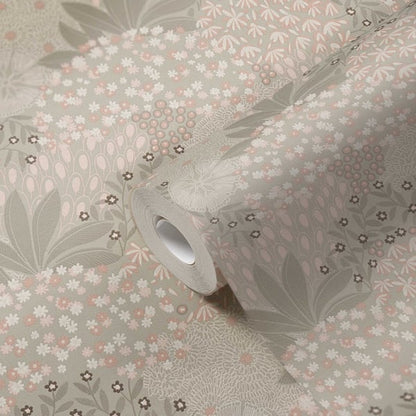 Roll of beige wallpaper with a floral motif featuring blossoms and leaves.