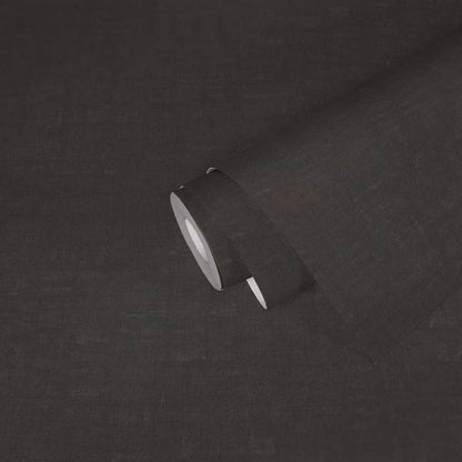 Dark charcoal linen fabric close-up with rolled edge and subtle texture, suitable for upholstery.