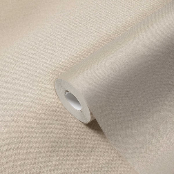 Beige linen-textured wallpaper roll, partially unrolled, fabric-like wall covering.