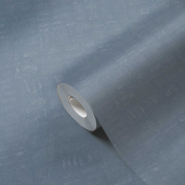 Blue textured wallpaper roll curling outward, white core visible, linen effect matte finish for walls.
