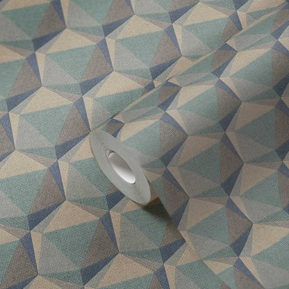 Geometric teal, blue, and beige triangle-pattern fabric with a gray masking tape roll resting on it.