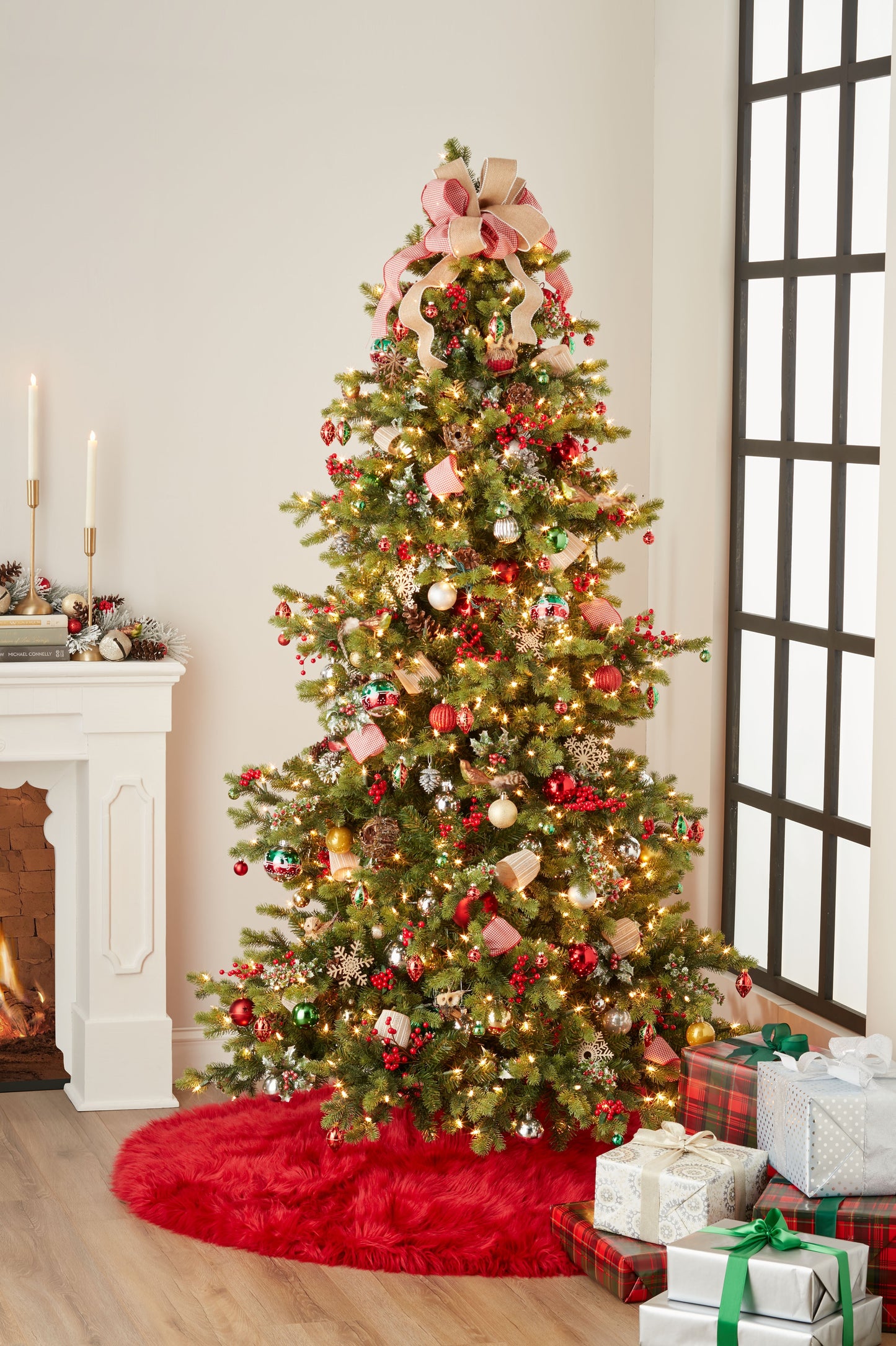 Red furry tree skirt, 5' round, around the base of a Christmas tree with warm white lights, pink ribbons, red and gold ornaments, and wrapped gifts.